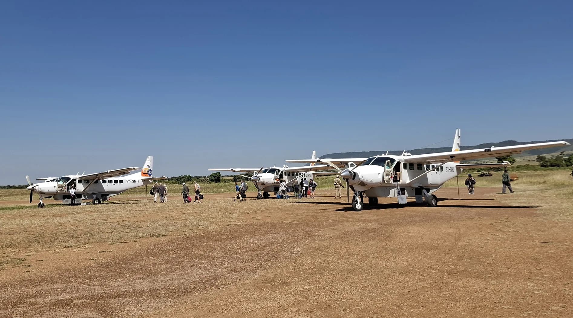 Passengers walking from Fly ALS Grand Caravans on a bush airstrip