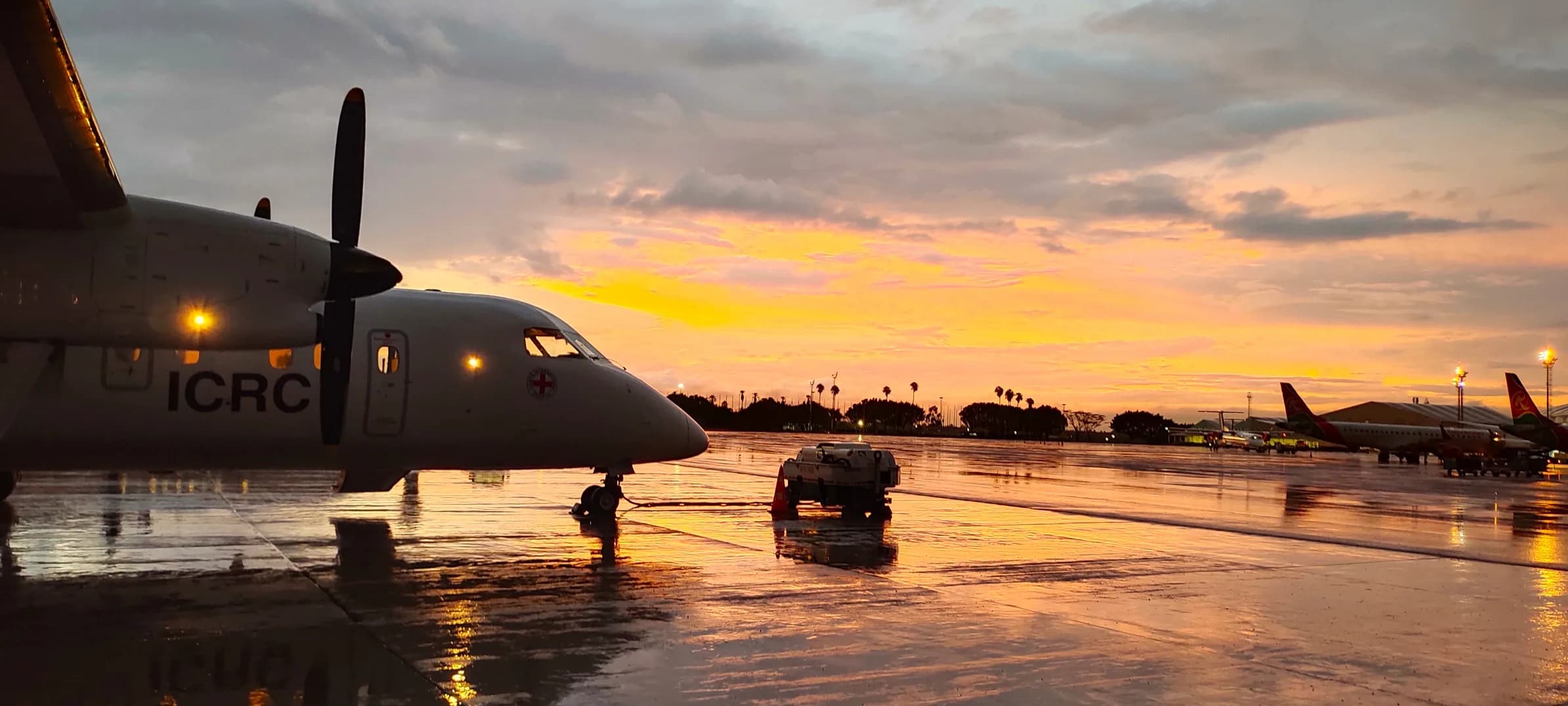 An ALS Dash 8 in ICRC colours on a wet apron at dusk