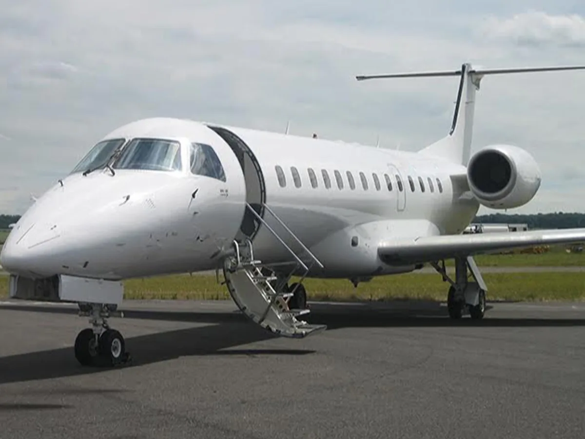 An ALS Embraer ERJ-135, plain white, airstair down