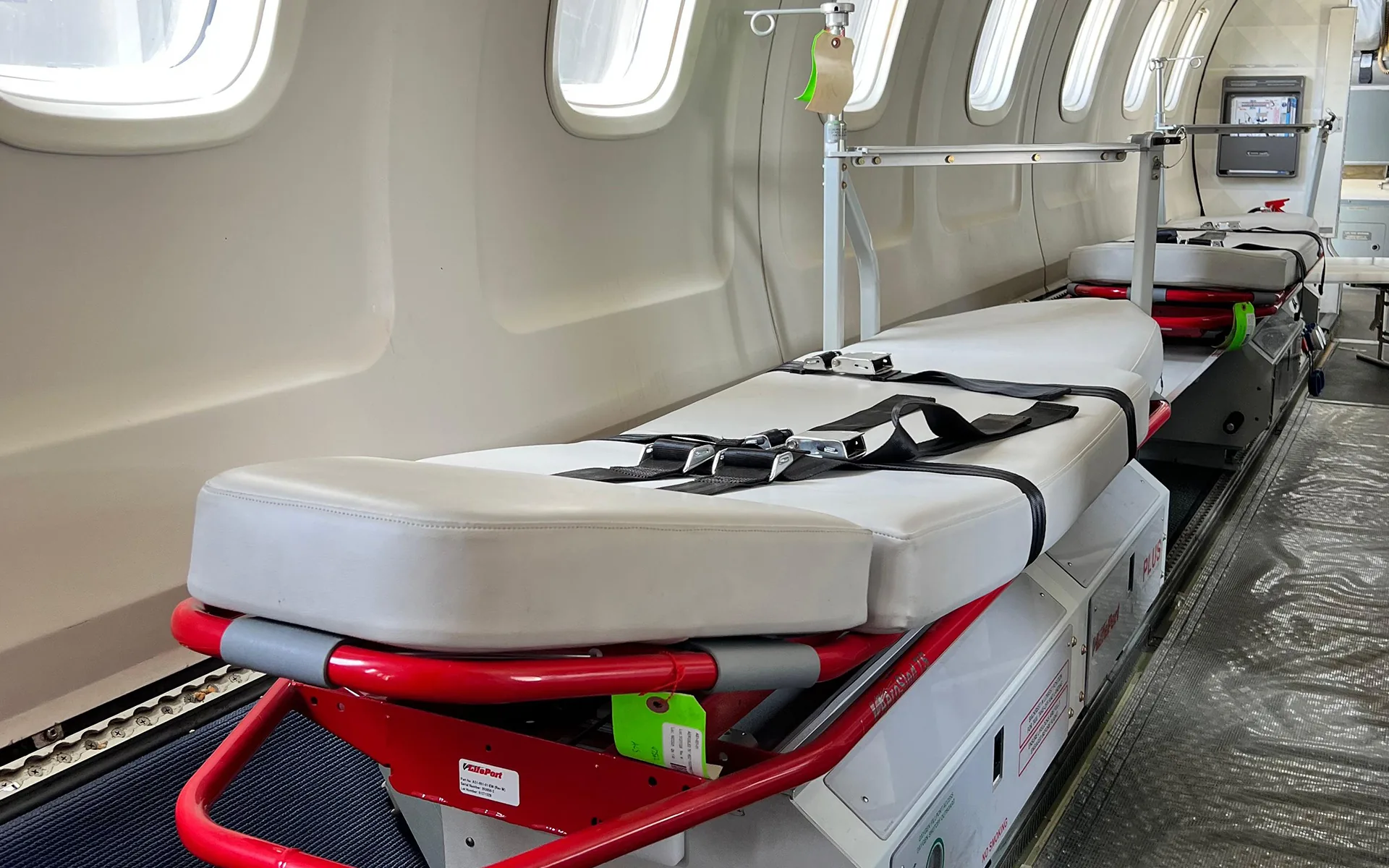 Two LifePort stretchers fitted along the cabin of an ALS Embraer air ambulance