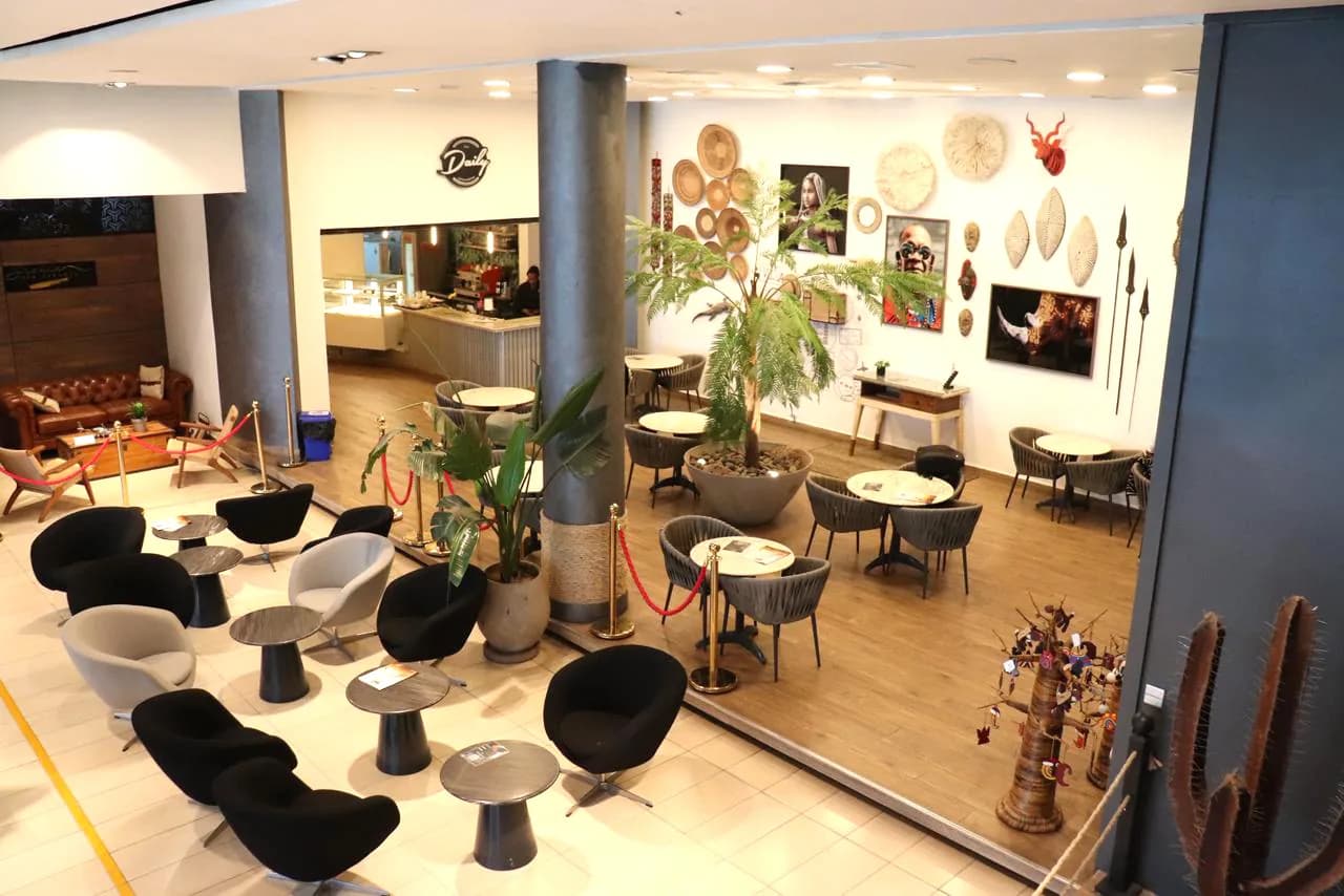 The lounge at the ALS Terminal, Wilson Airport: armchairs, a café counter and African art on the walls