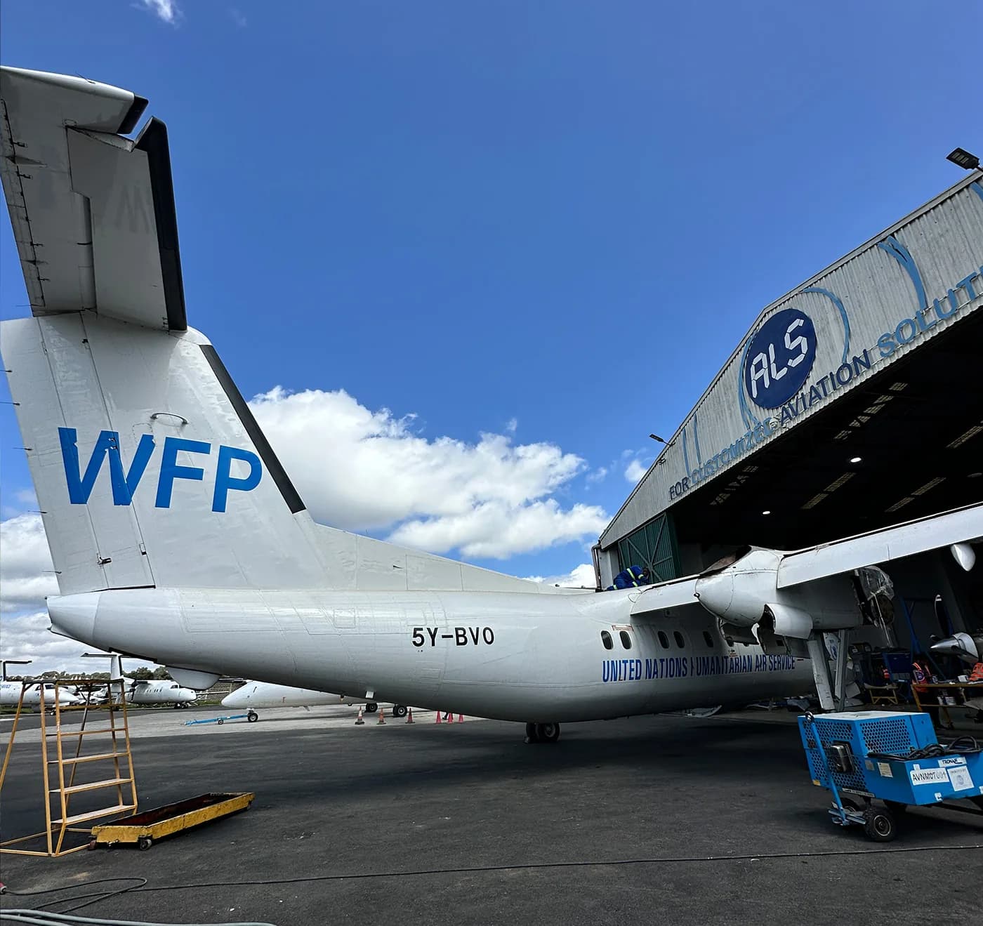 The WFP tail of an ALS Dash 8 outside the hangar at Wilson Airport