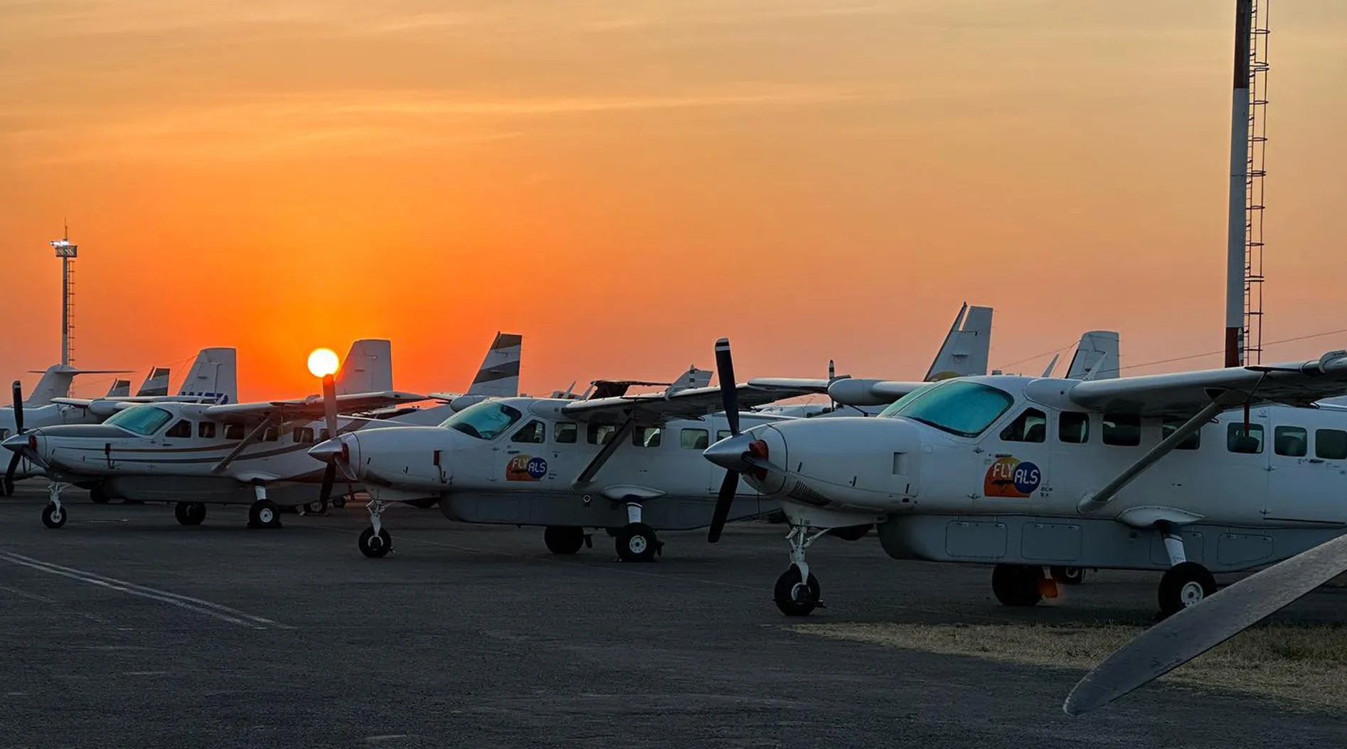 ALS Grand Caravans lined up on the apron at sunset