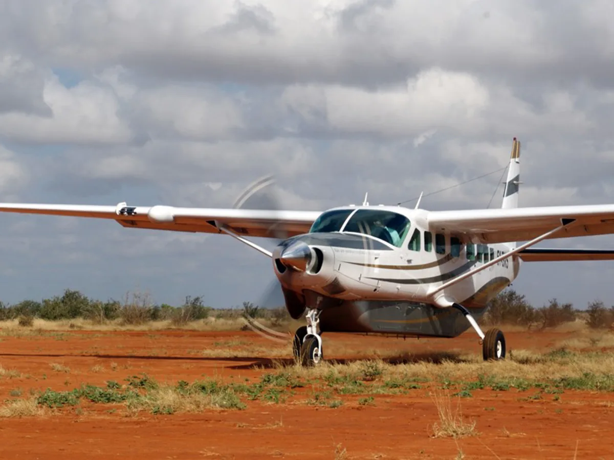 A Cessna Grand Caravan on a red-earth strip